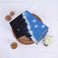 Sungudi cotton saree with white tie-dye motifs blue and navy blue design gold check pattern folded top view