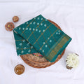 Sungudi cotton saree with white tie dye motifs and gold checkered pattern in green folded top view with zari border