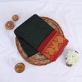 Sungudi cotton saree with gold zari checks body and green peacock motif border folded top view on wicker basket
