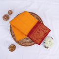 Sungudi cotton saree with gold check pattern and red peacock zari border in yellow folded top view