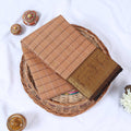 Venkatagiri cotton saree with beige checked body gold elephant zari motifs and contrast zari border folded top view.