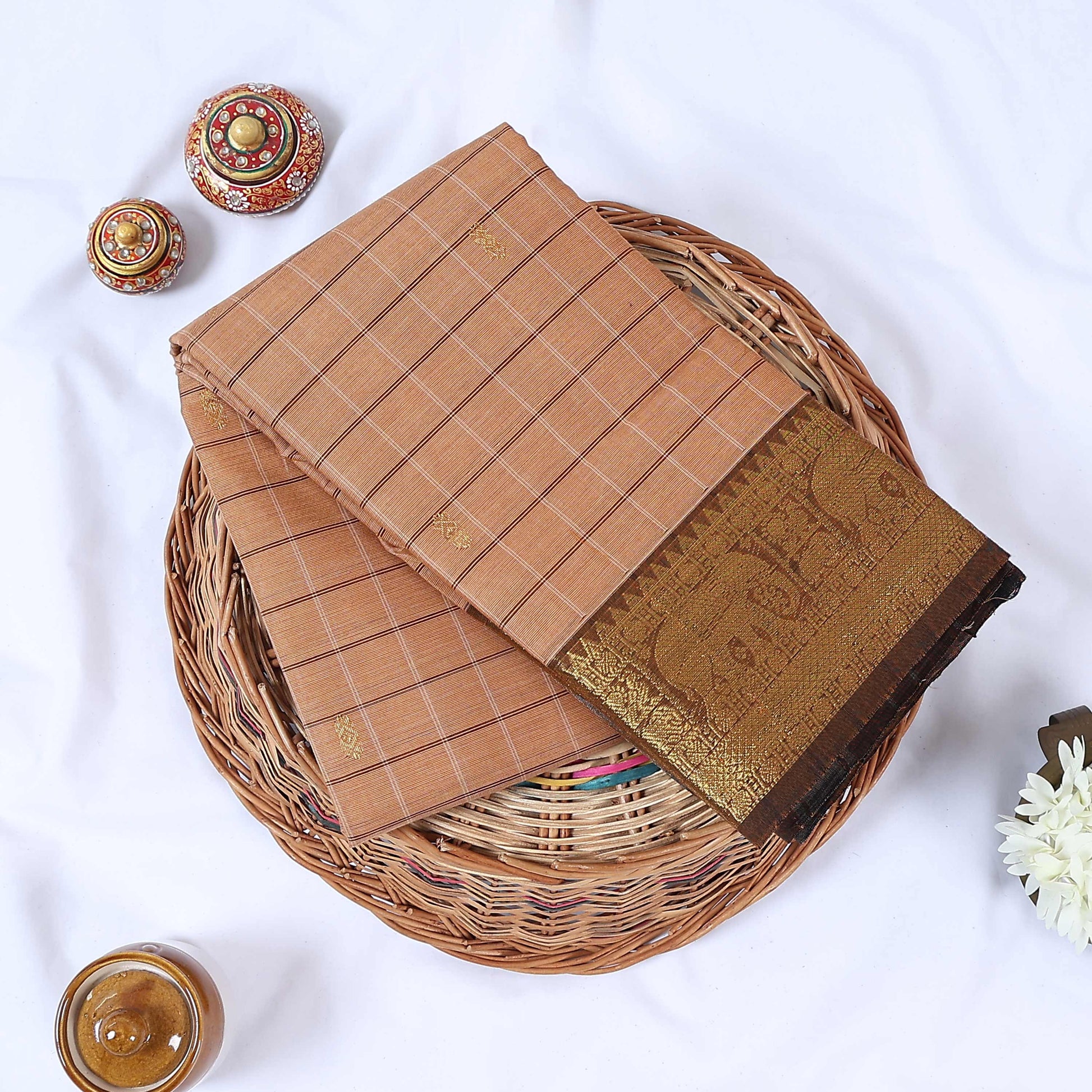 Venkatagiri cotton saree with beige checked body gold elephant zari motifs and contrast zari border folded top view.