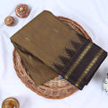 Venkatagiri cotton saree with a brown body black contrast zari border and butta motifs top folded view.