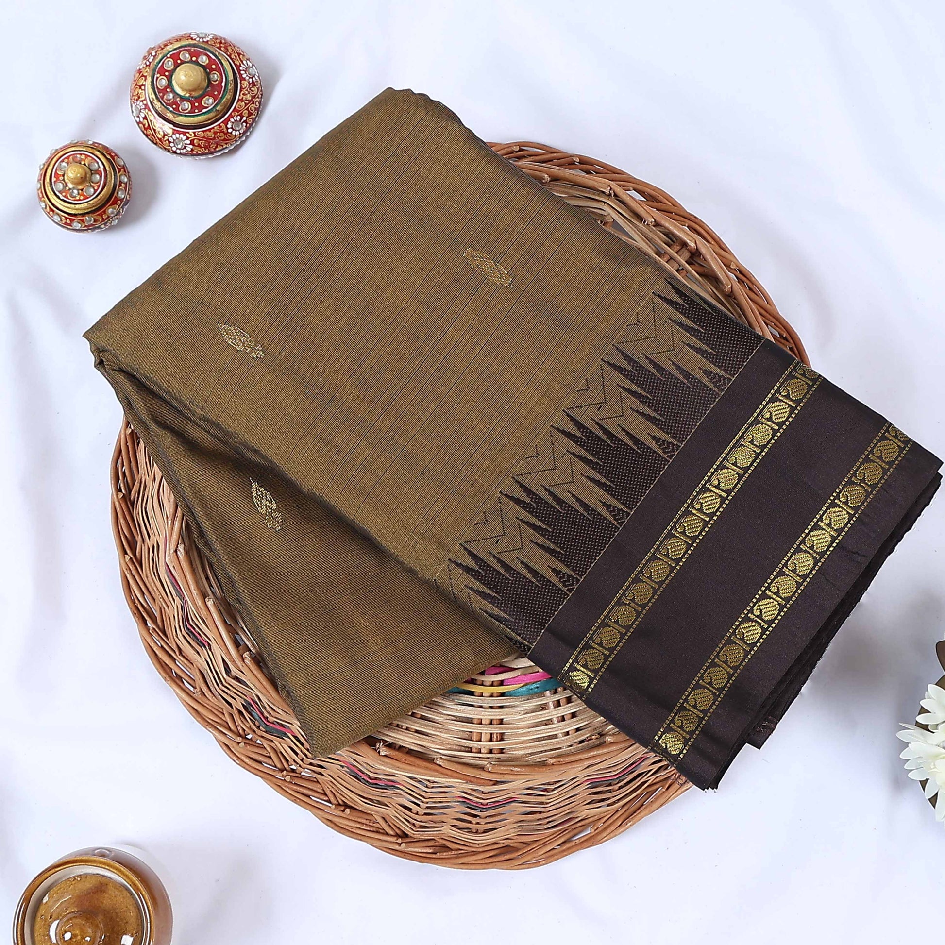 Venkatagiri cotton saree with a brown body black contrast zari border and butta motifs top folded view.