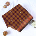 Venkatagiri cotton saree with brown and maroon checked body woven buttas and zari floral border folded flat view.