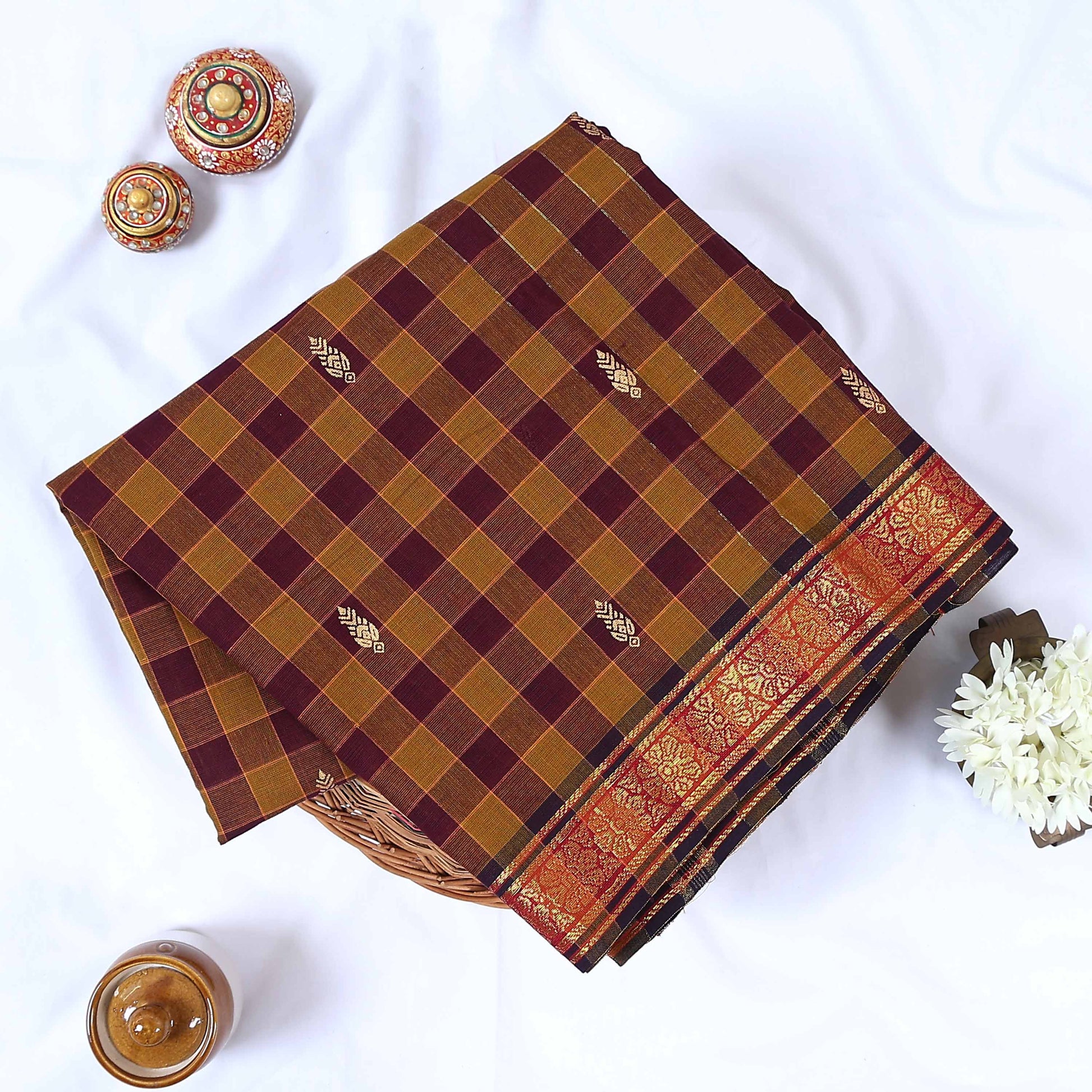 Venkatagiri cotton saree with brown and maroon checked body woven buttas and zari floral border folded flat view.