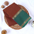Top view of brown Venkatagiri cotton saree with checks green contrast border and gold zari motifs.