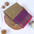 Venkatagiri cotton saree with gold stripes purple zari border and pink edge folded top view on wicker tray.