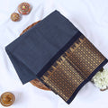 Venkatagiri cotton saree with zari woven temple border in grey and navy blue folded flat lay front view.