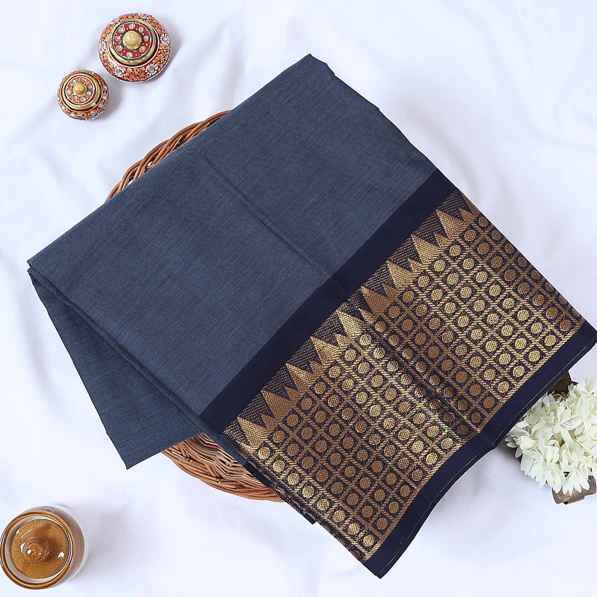 Venkatagiri cotton saree with zari woven temple border in grey and navy blue folded flat lay front view.