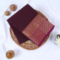 Folded Venkatagiri cotton saree in dark Purple a plain body and intricate gold zari floral border.