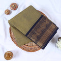 Venkatagiri cotton saree with olive green body and navy blue zari border folded top view display