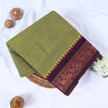 Venkatagiri cotton saree with olive green body and maroon temple paisley zari border folded front view.