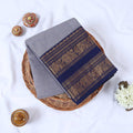 Venkatagiri cotton saree with broad peacock elephant and floral zari border in grey and navy blue folded flat top view