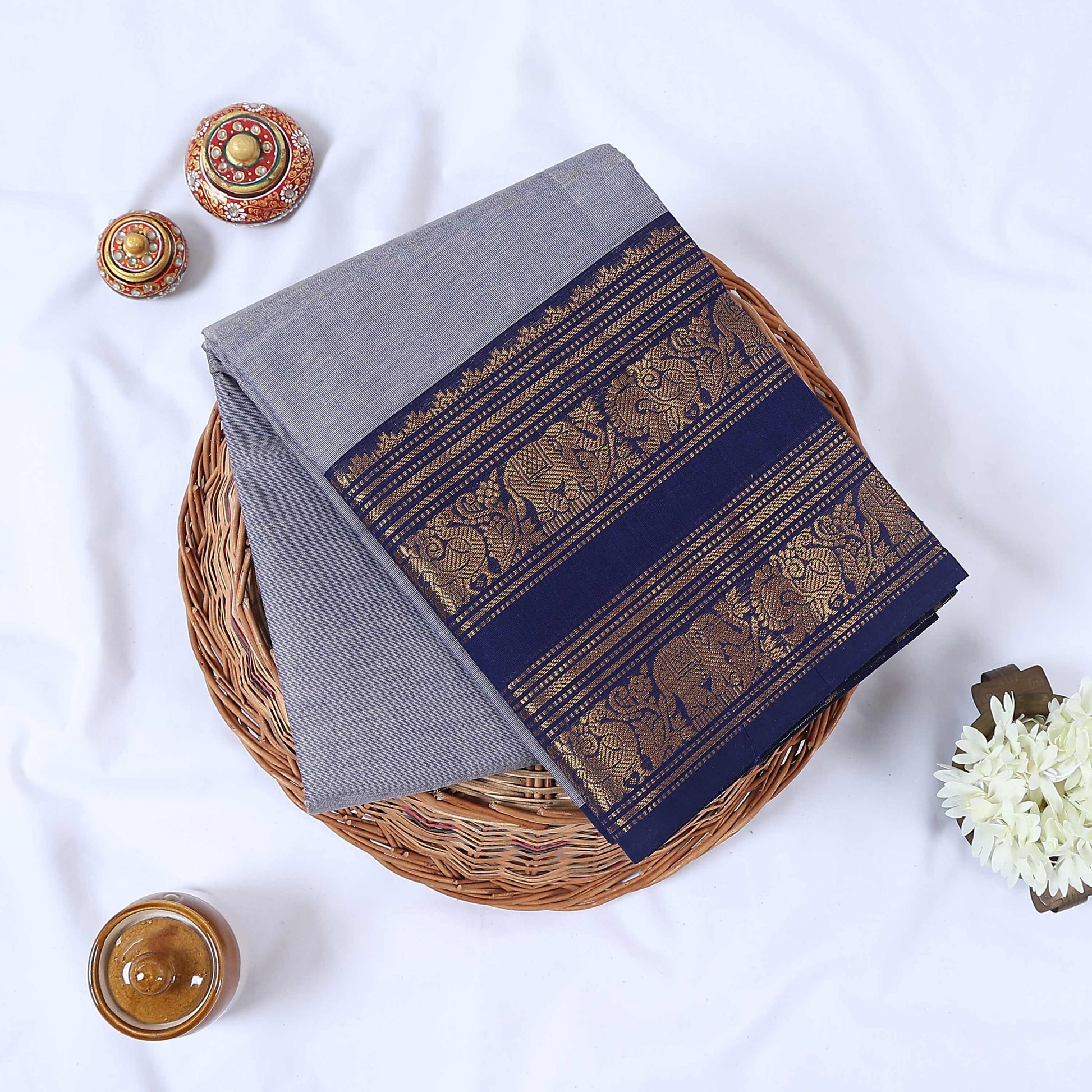 Venkatagiri cotton saree with broad peacock elephant and floral zari border in grey and navy blue folded flat top view