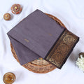 Venkatagiri cotton saree with small zari buttas grey body and black  paisley zari border folded top view.