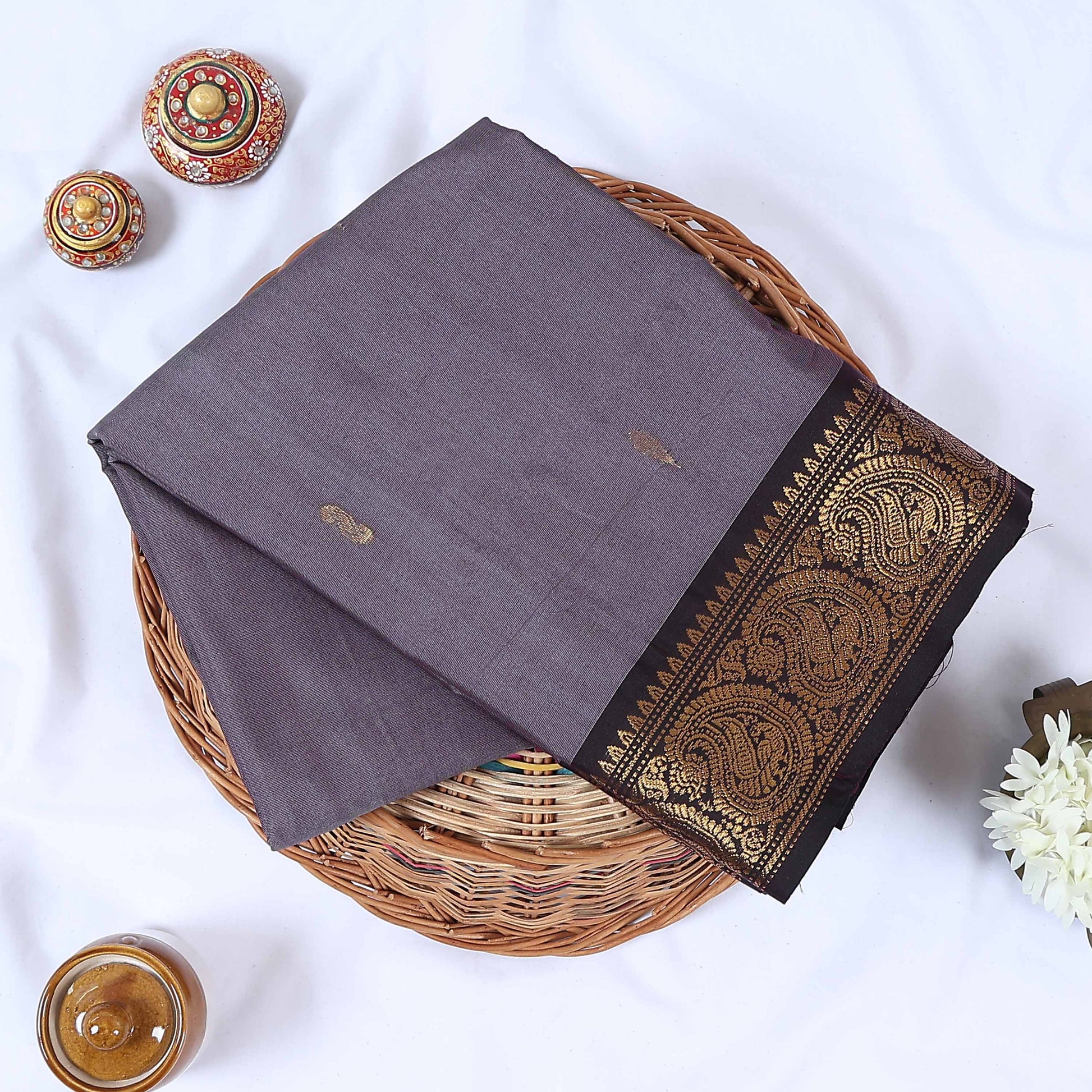 Venkatagiri cotton saree with small zari buttas grey body and black  paisley zari border folded top view.