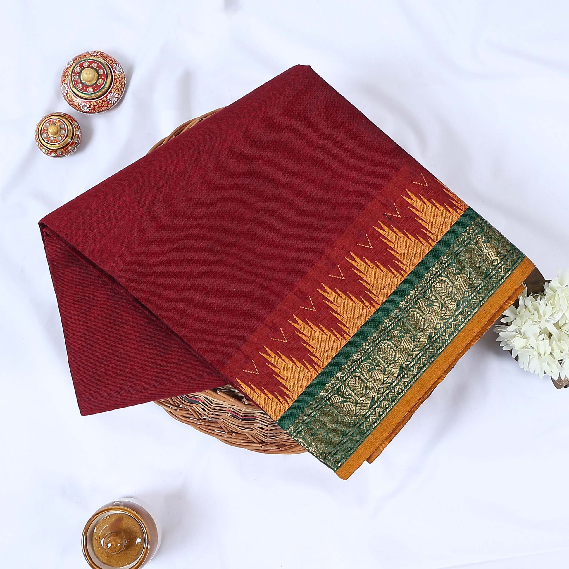 Venkatagiri cotton saree with broad floral zari border in maroon and green folded front view