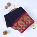 Venkatagiri cotton saree with navy blue body and maroon gold zari border folded flat lay top view