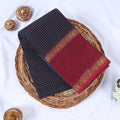 Top view of navy blue Venkatagiri cotton saree with checks maroon contrast border and gold zari motifs.