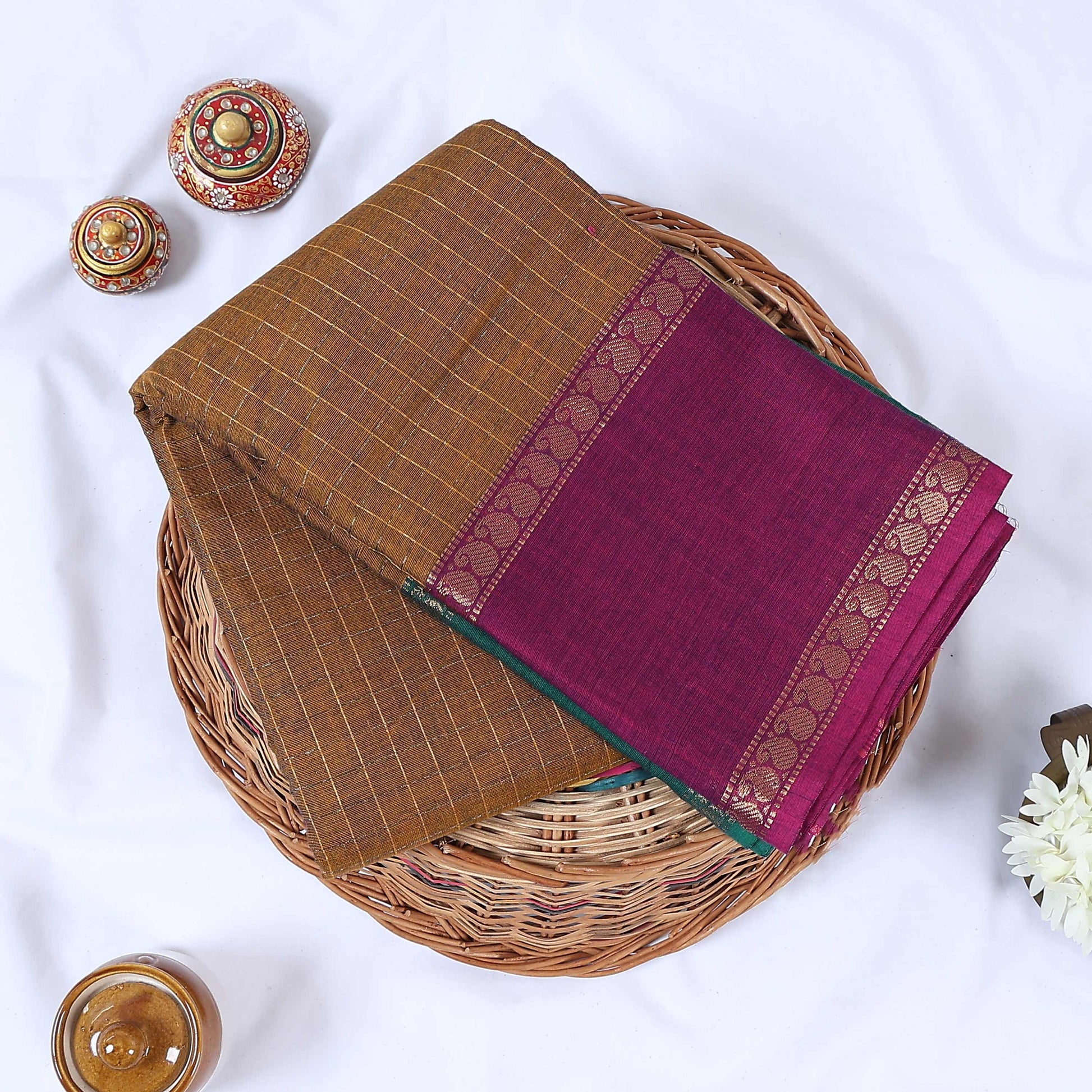 Venkatagiri cotton saree with gold zari checked body and contrast maroon zari border in olive neatly folded top view