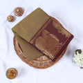 Venkatagiri cotton saree with olive green body and maroon gold zari peacock border folded top view.