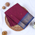 Venkatagiri cotton saree with small zari buttas purple body and royal blue paisley zari border folded top view.