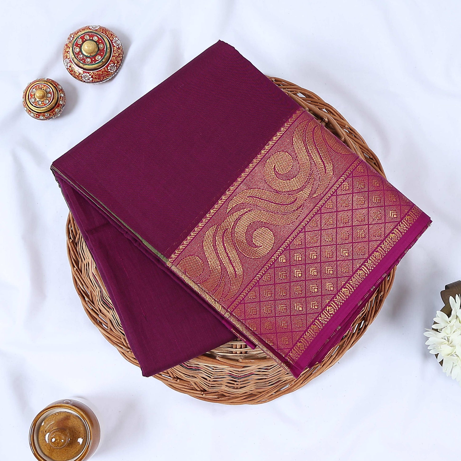 Folded Venkatagiri cotton saree in Purple a plain body and intricate gold zari floral border.
