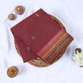 Venkatagiri cotton saree with maroon body gold buttas and pink zari border folded top view