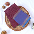 Top view of purple Venkatagiri cotton saree with checks blue contrast border and gold zari motifs.