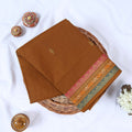 Venkatagiri cotton saree with elegant zari buttas and multicolor woven border in brown front flat lay view.