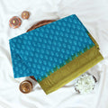Blue Voile Cotton Saree with Floral Butta Weave and Contrast Green Zari Border Folded Top View