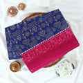 Blue Voile cotton saree with tribal print body and pink contrast folk art border folded top view 