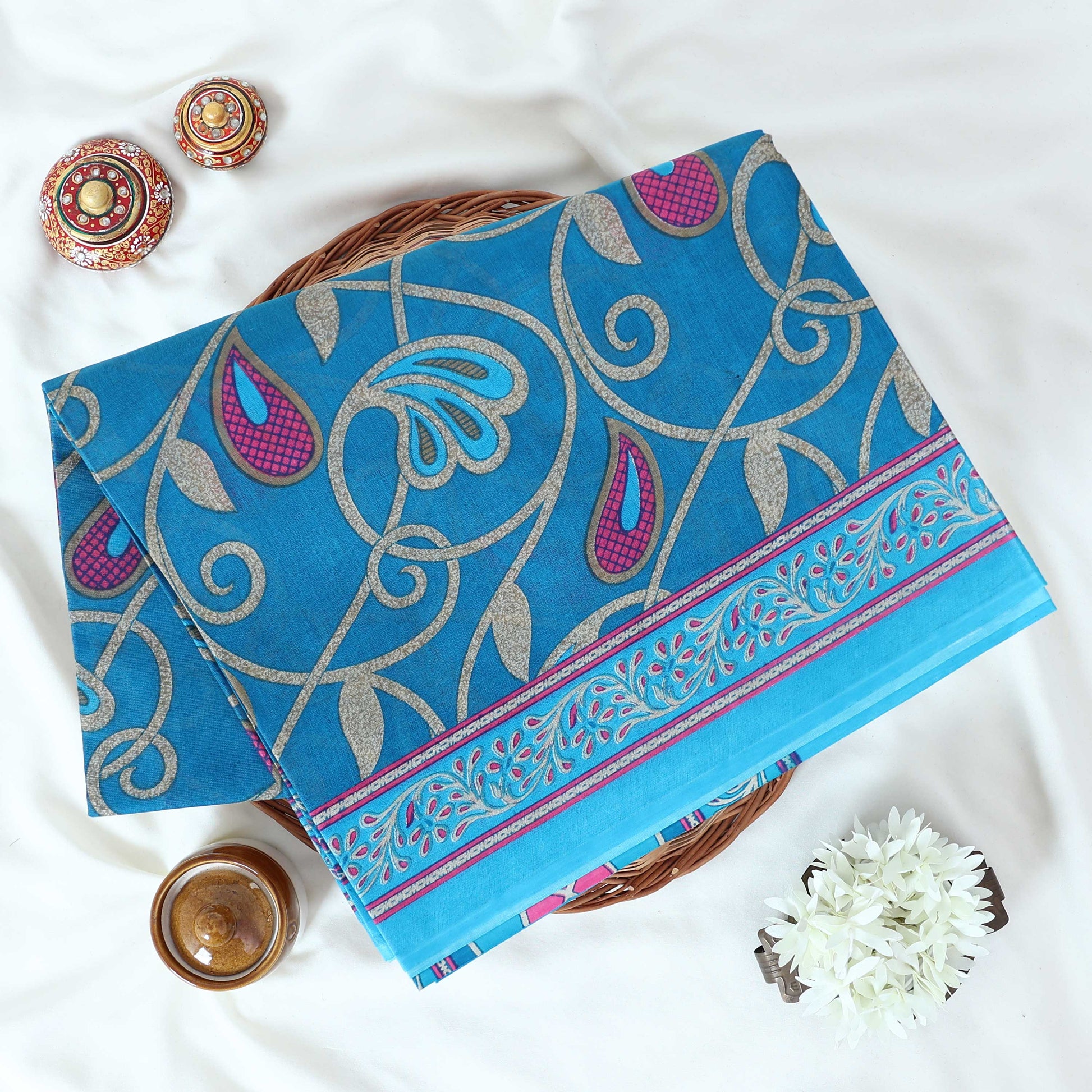 Blue Voile Cotton Saree with paisley floral print and contrast floral printed border folded top front view