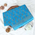 Blue Voile cotton saree with floral vine butta print and decorative border folded flat lay view
