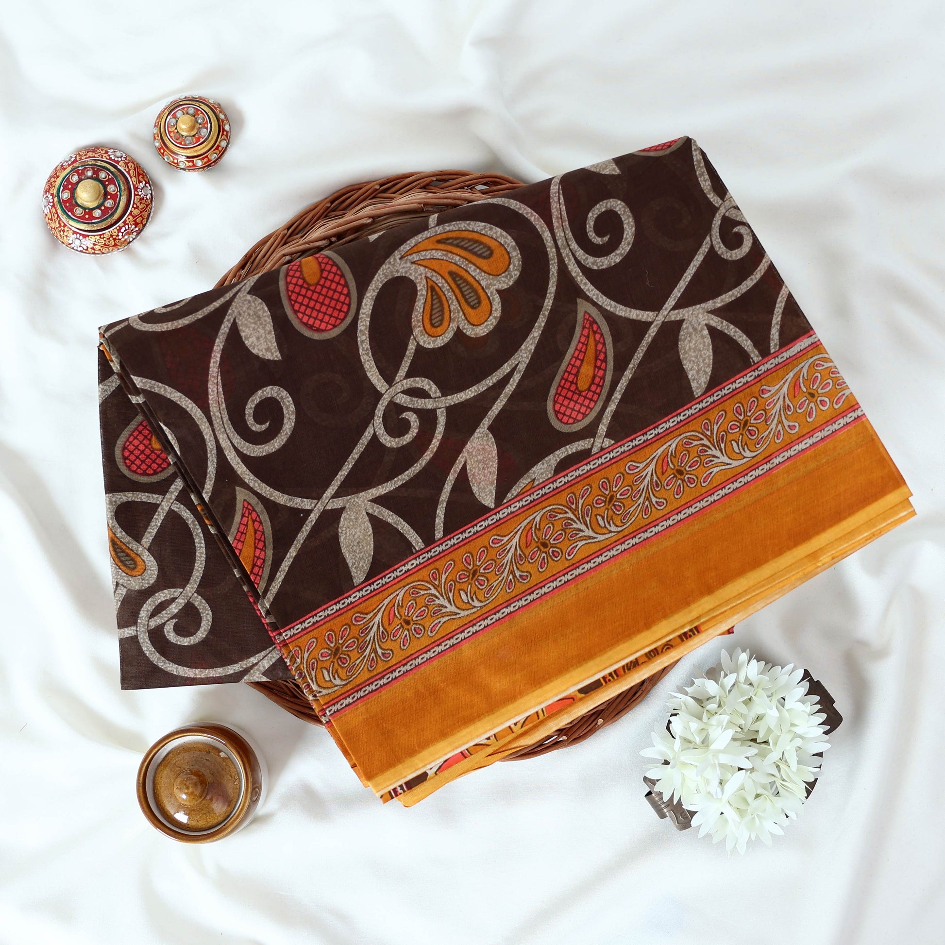 Brown Voile Cotton Saree with paisley floral print and contrast floral printed border folded top front view