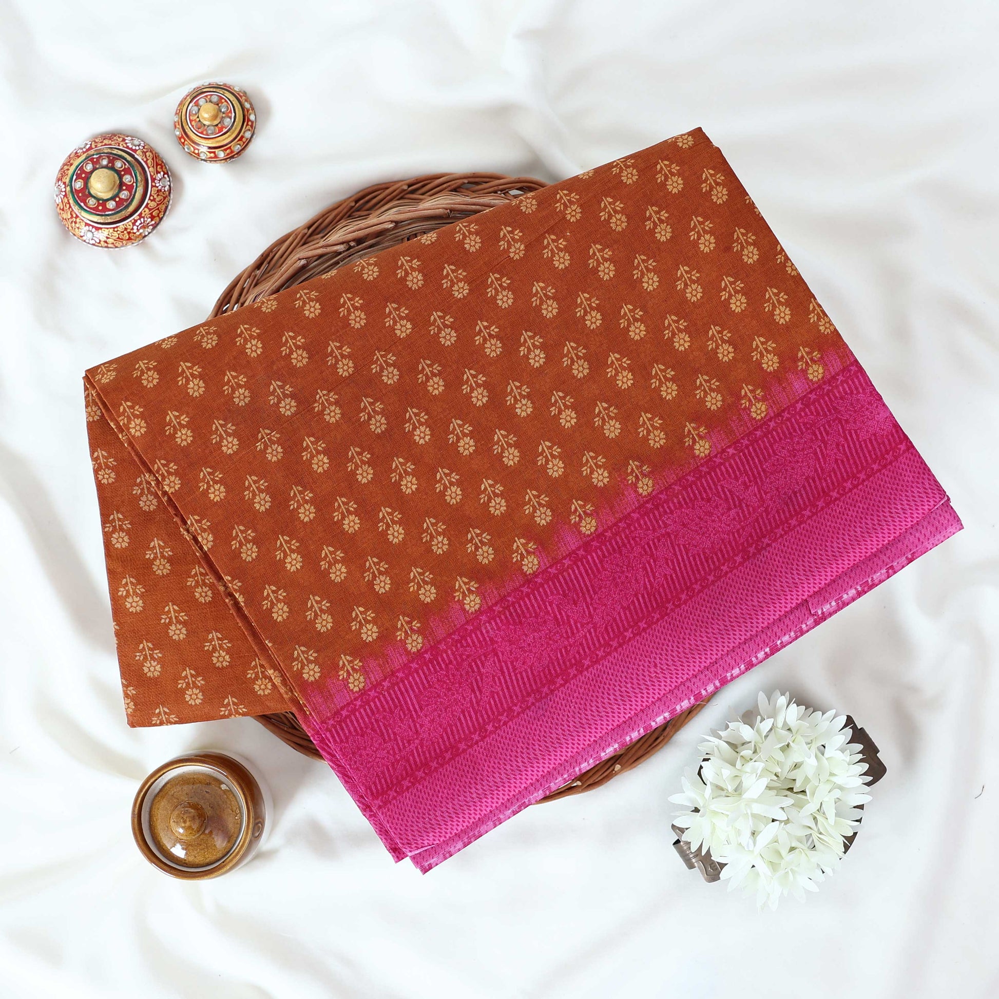 Brown Voile Cotton Saree with Floral Butta Weave and Contrast Pink Zari Border Folded Top View