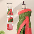 Green voile cotton saree with floral butta woven pattern and contrast orange zari border front draped view on mannequin
