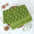 Green Voile cotton saree with floral vine butta print and decorative border folded flat lay view