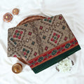 Voile cotton saree with geometric ethnic print and contrast border in olive green top view folded display