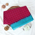 Pink Voile Cotton Saree with Floral Butta Weave and Contrast Blue Zari Border Folded Top View