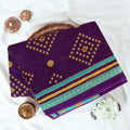 Voile cotton saree with geometric Bandhani inspired motifs and multicolor woven border in purple folded top view