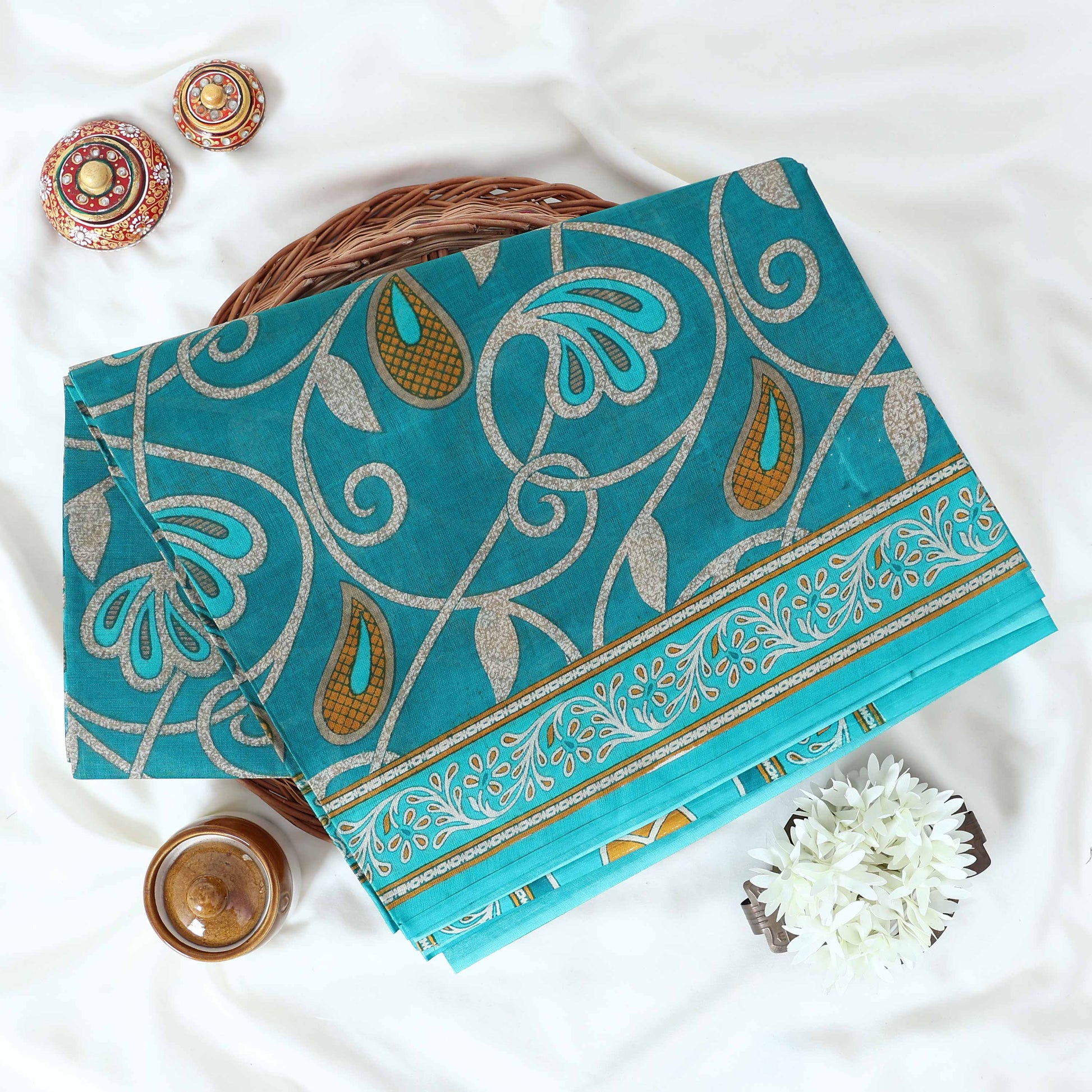 Teal Voile Cotton Saree with paisley floral print and contrast floral printed border folded top front view