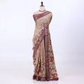 Women's Semi Tussar saree with beige floral print, maroon woven border and decorative pallu, front view.