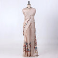 A beige and white striped saree with colorful floral prints