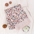 Folded A beige and white striped saree with colorful floral prints