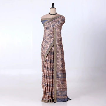 A patterned beige and blue saree 