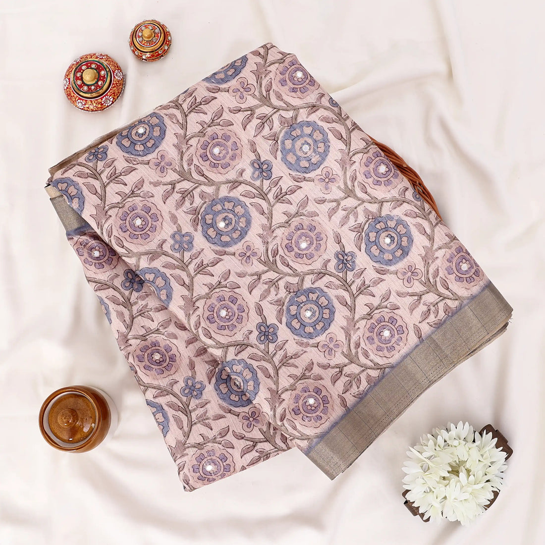 A patterned beige and blue saree 