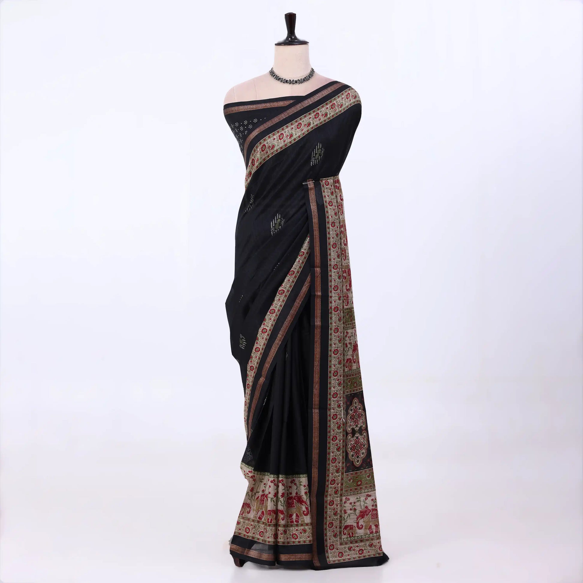 A black cotton saree with intricate multicolor floral and geometric borders