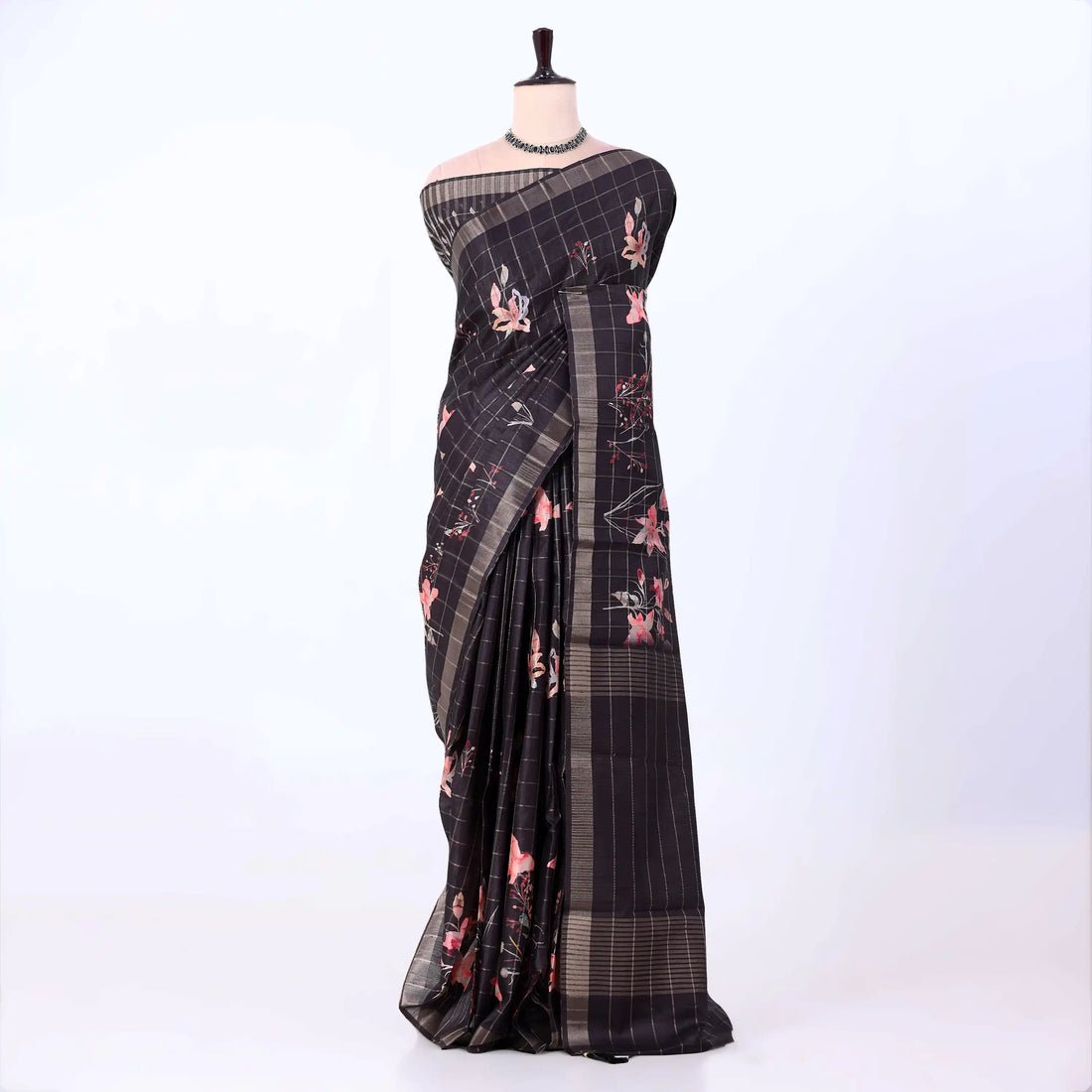 A black and brown plaid saree with pink floral prints